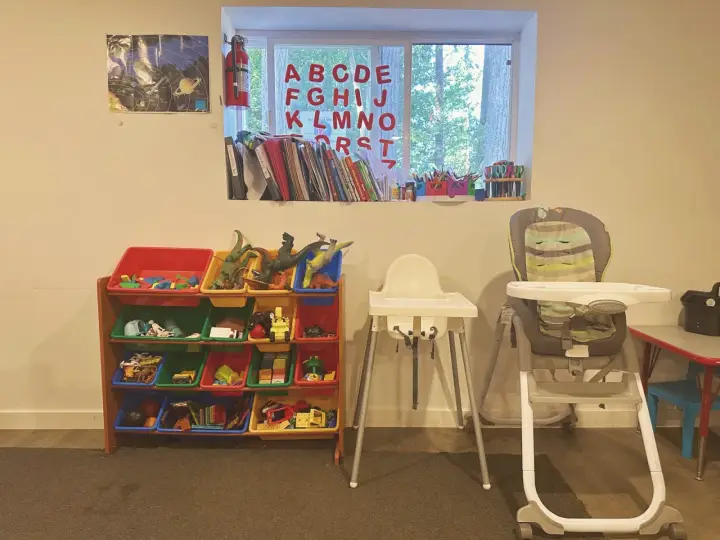 Books, toys, high chairs, and learning materials at Angel Family Daycare